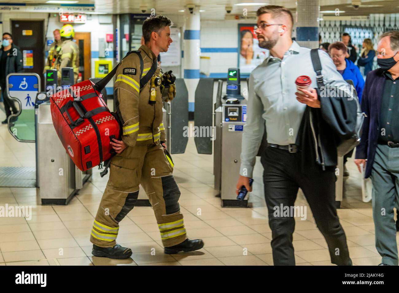 London, Großbritannien. 31.. Mai 2022. Die Feuerwehrleute kehren mit ihrem erste-Hilfe-Set zum Einsatzgebiet zurück - die Londoner Feuerwehr, die Polizei und der Rettungsdienst, einschließlich des Air Ambulance, nehmen an einem Vorfall an der U-Bahn-Station Green Park Teil. Es wurde berichtet, dass eine Person unter einem Zug war, aber der Krankenwagen nicht benötigt wurde und die Dienste der Dienststellen bald danach abreisten. Kredit: Guy Bell/Alamy Live Nachrichten Stockfoto