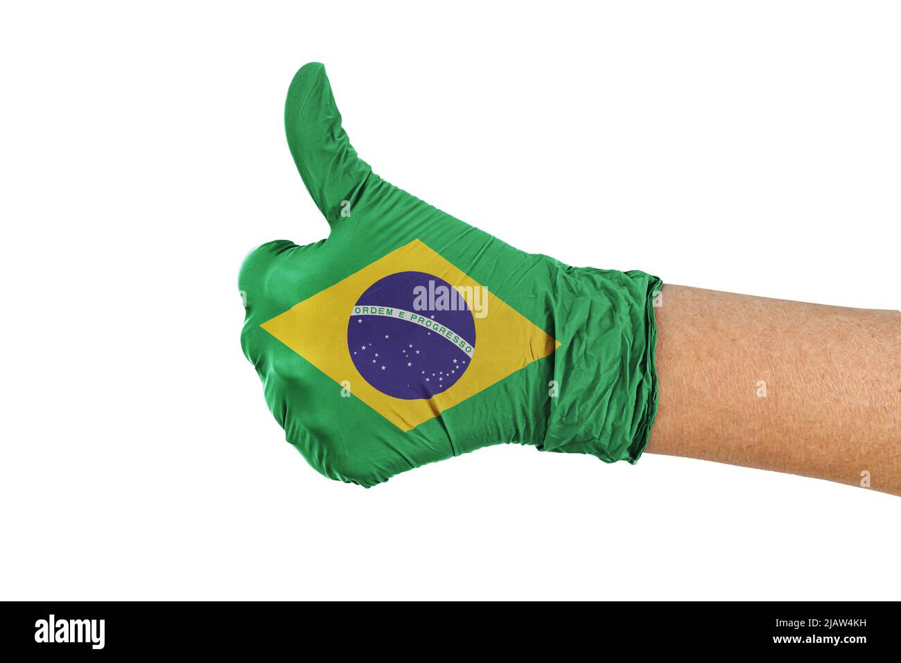 Brasil Flagge auf einem Handschuh zeigt Daumen nach oben Zeichen Stockfoto