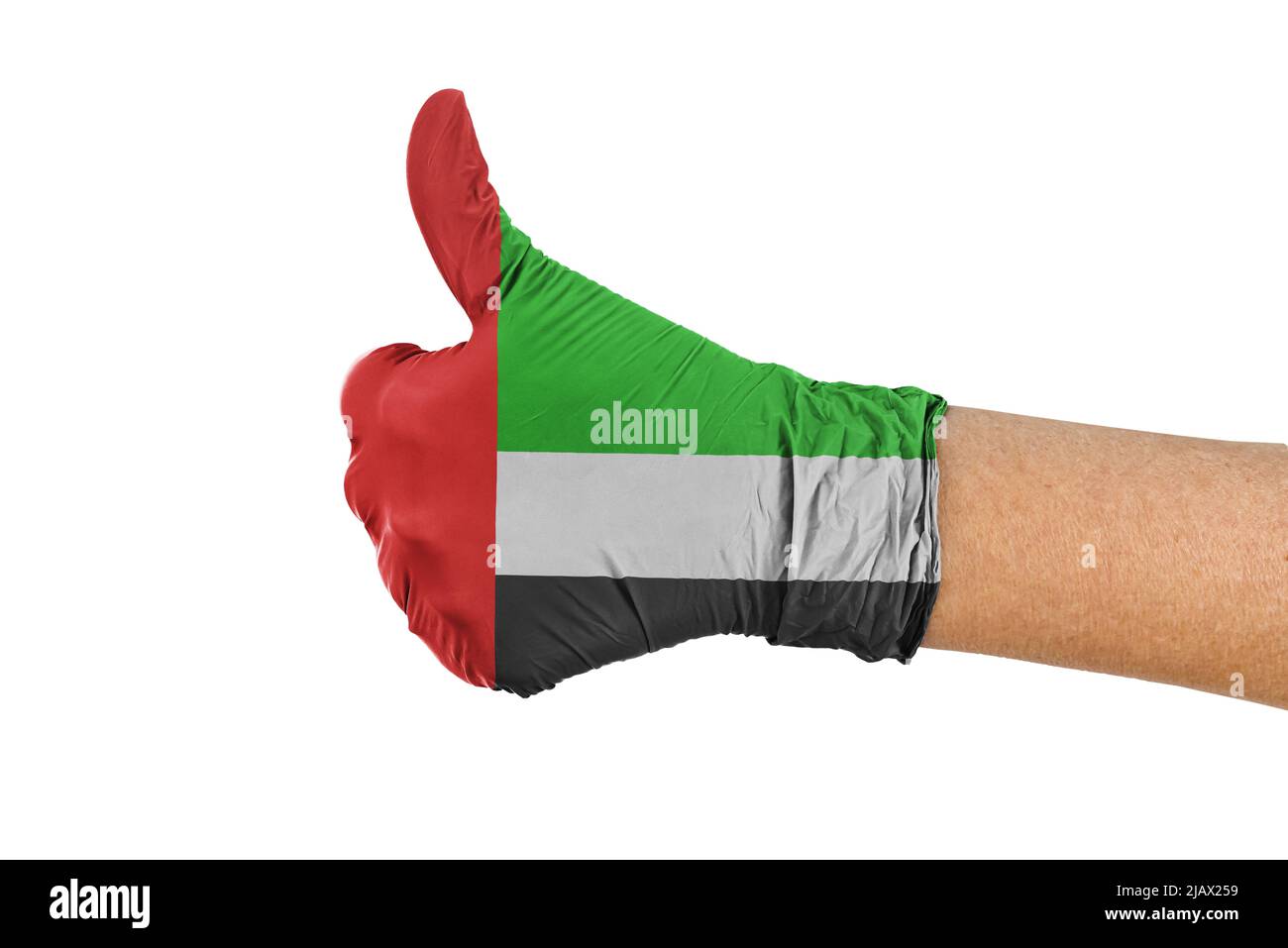 Flagge der Vereinigten Arabischen Emirate auf einem medizinischen Handschuh mit Daumen nach oben Stockfoto