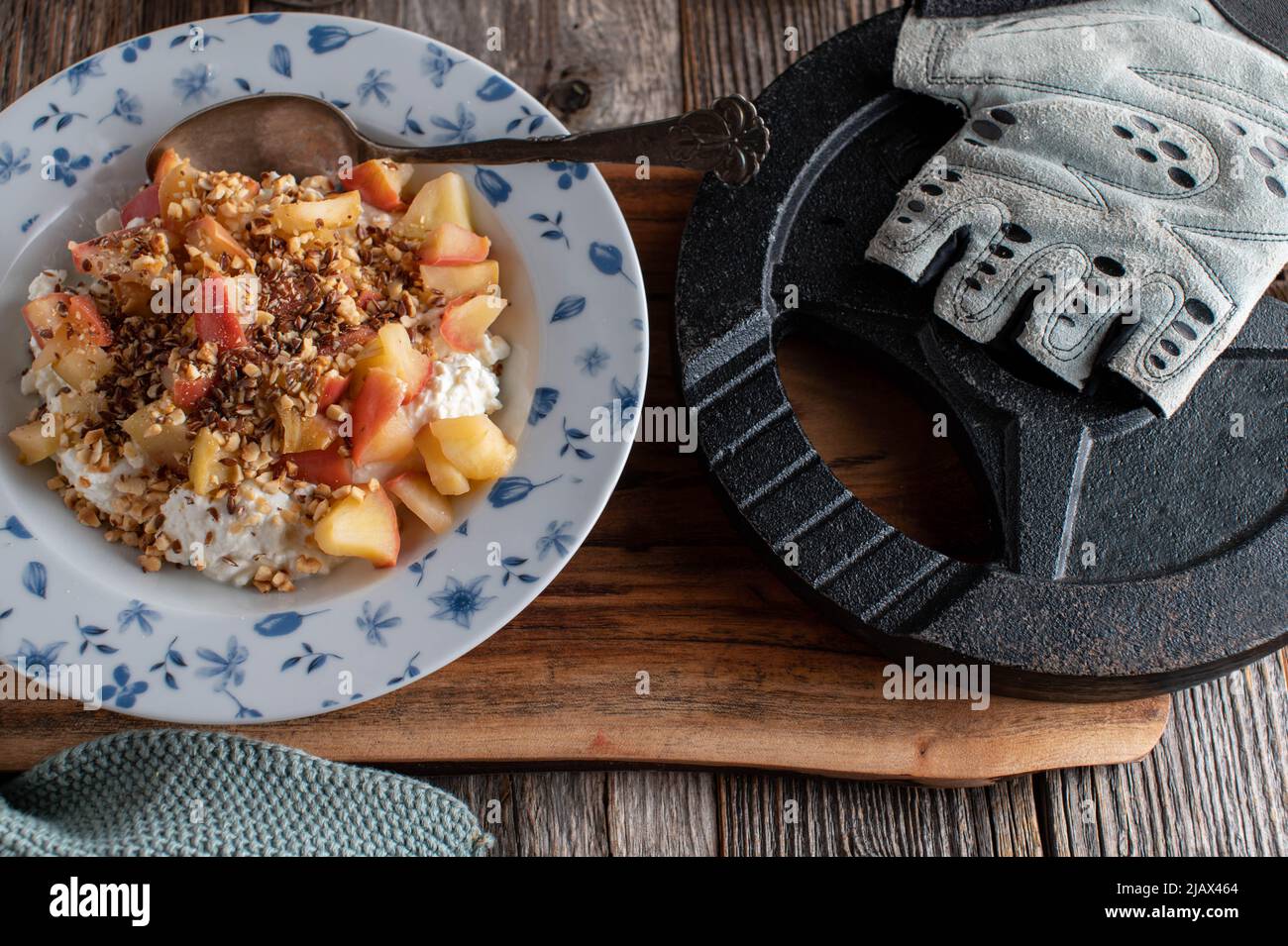 Fitness-Frühstück mit Hüttenkäse. Serviert mit gekochten Äpfeln, gerösteten Haselnüssen und Leinsamen Stockfoto