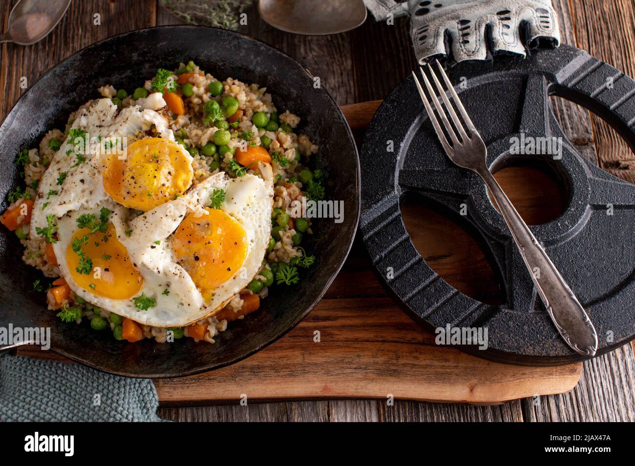 Fitnessmenü mit Spiegeleiern, braunem Reis und Gemüse Stockfoto