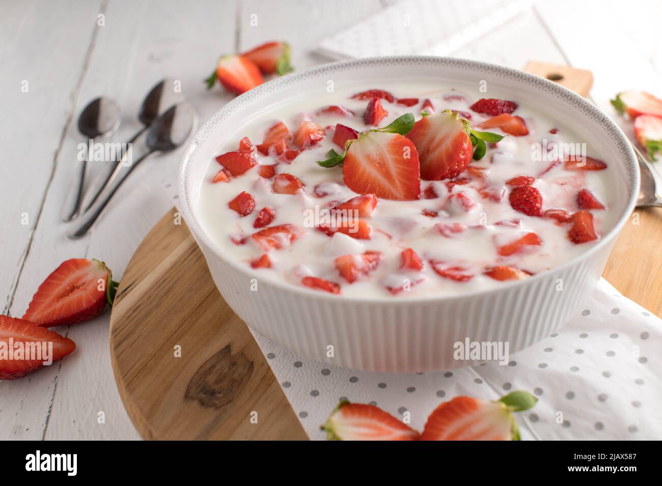 Klobiger Erdbeerjoghurt in einer Schüssel auf weißem Küchentisch. Gesundes Dessert Stockfoto