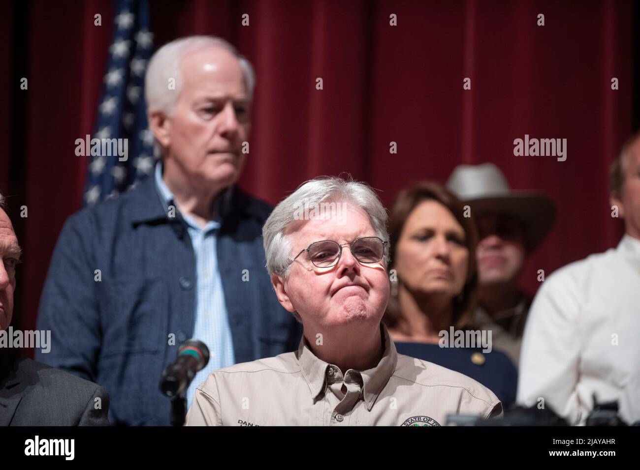 Uvalde Texas USA, Mai 25 2022: Beamte des Staates Texas, darunter US-Senator JOHN CORNYN (links) und LT. Gov. DAN PATRICK (sitzend) hält einen Tag nach dem Eintritt eines 18-jährigen Schützen in die Robb-Grundschule eine Pressekonferenz an der Uvalde High School ab und tötete 19 Schüler und zwei Lehrer. ©Bob Daemmrich Stockfoto