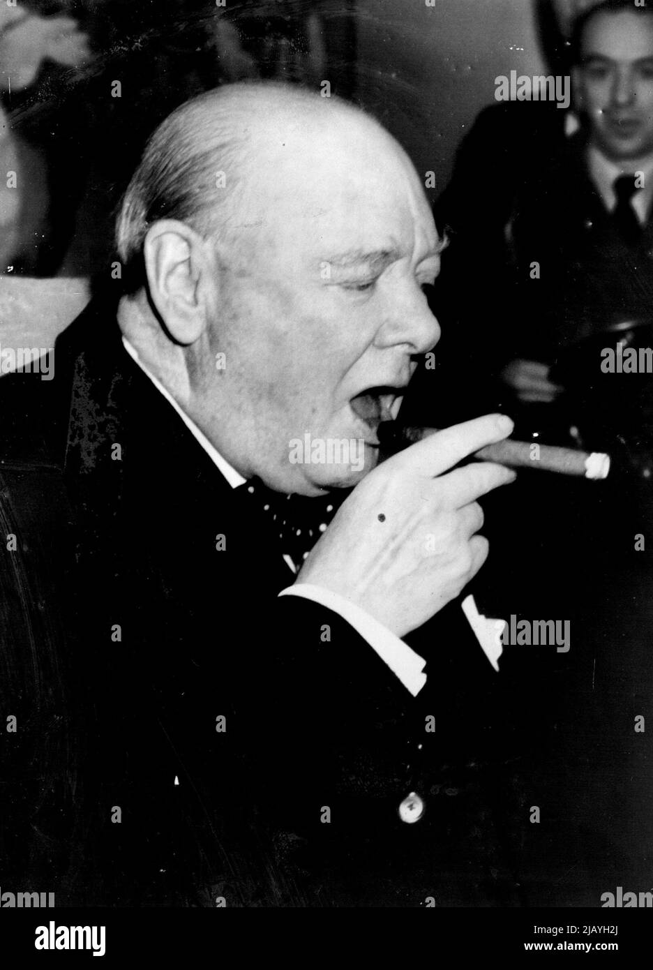 Mr. Churchill und seine Zigarre: Mr. Winston Churchill, der Premierminister, lässt sich zurück, um mit offensichtlichem Vergnügen eine seiner Zigarren zu genießen, als er an Bord der Linie Queen Mary nach seinem Urlaub in Jamaika, Britisch-Westindien, wieder in Southampton ankommt. 29. Januar 1953. (Foto von Planet News Ltd.). Stockfoto
