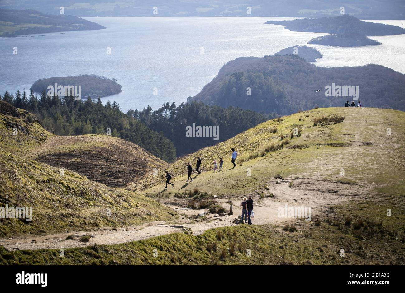 File photo dated 16/04/21 of people Walking on Conic Hill, above Loch Lomond at Balmaha, as a tech firm is hoping tourists over the Jubilee Bank Holiday weekend will give it the Data it needs to help prevent future overcrowding at visitor Hotspots. Stockfoto
