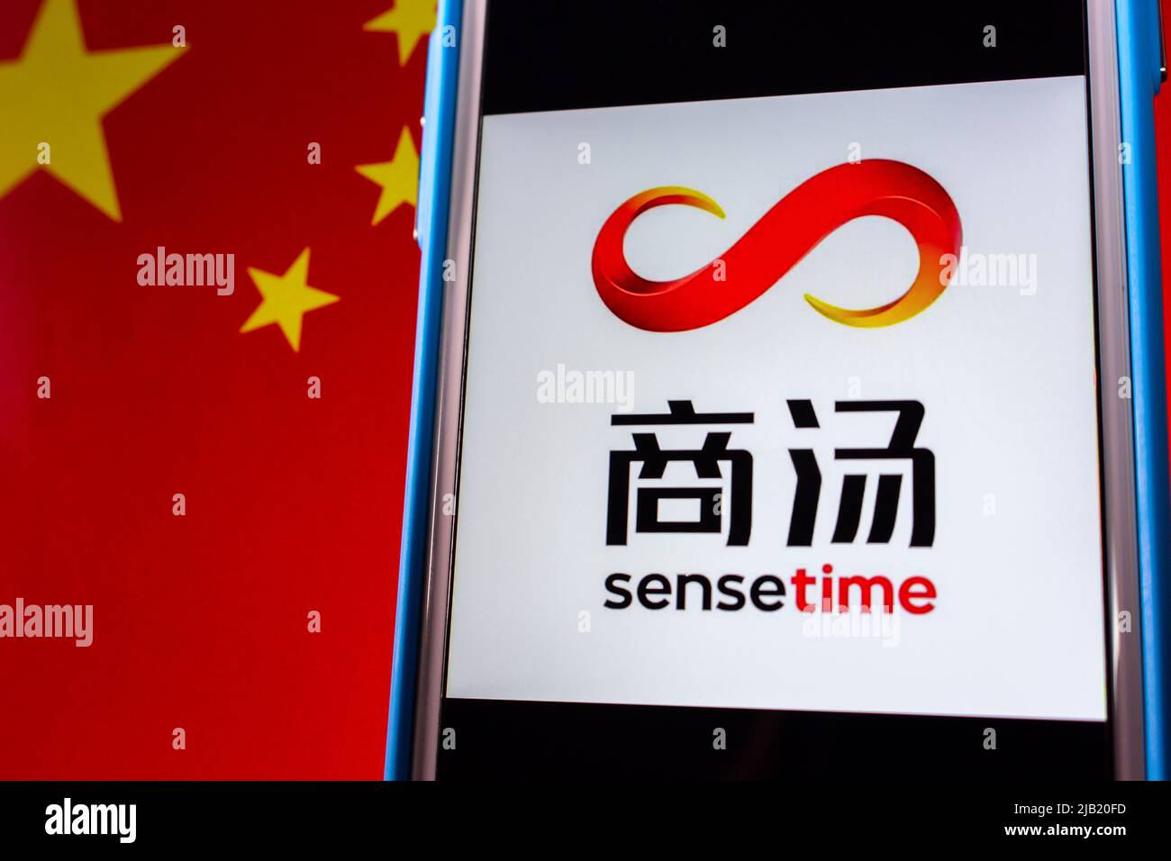 Kumamoto, JAPAN - Dez 14 2021 : das Logo von SenseTime, einem führenden Softwareunternehmen für künstliche Intelligenz mit Sitz in Hongkong, auf dem iPhone auf chinesischer Flagge. Stockfoto