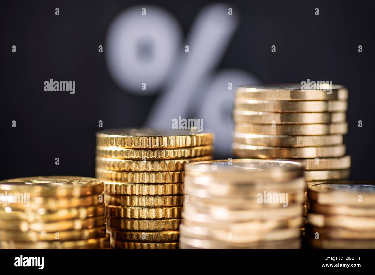 Stapel mit Münzen und Prozentzeichen im Hintergrund Stockfoto