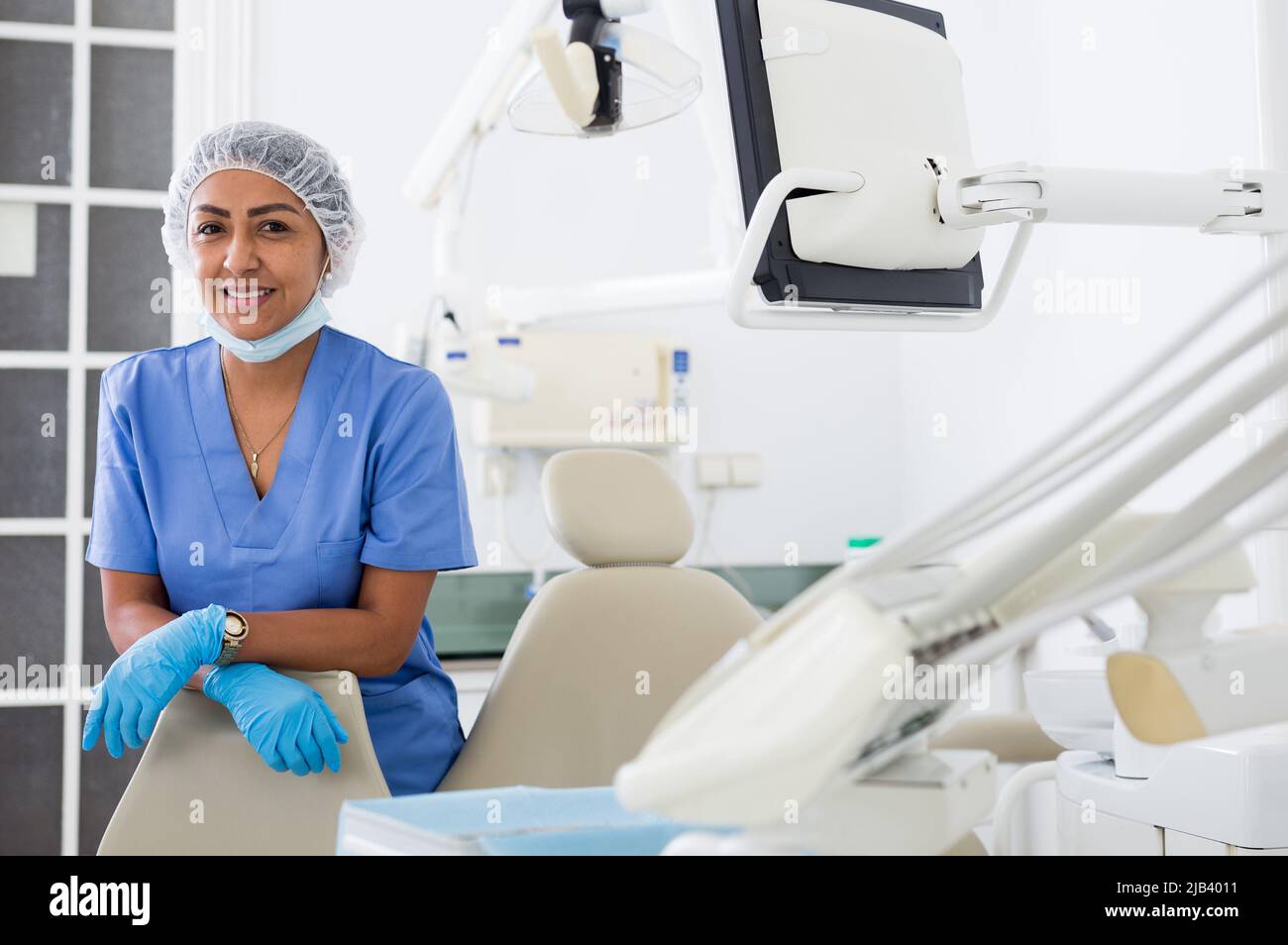 Lächelnde professionelle Zahnärztin Frau posiert in der Zahnklinik Stockfoto