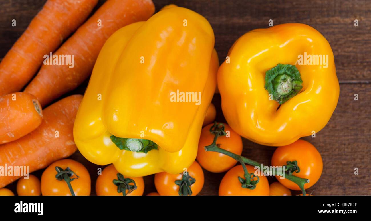 Bild von frischen veganen Bio-Lebensmitteln mit Orangengemüse auf Holz Stockfoto
