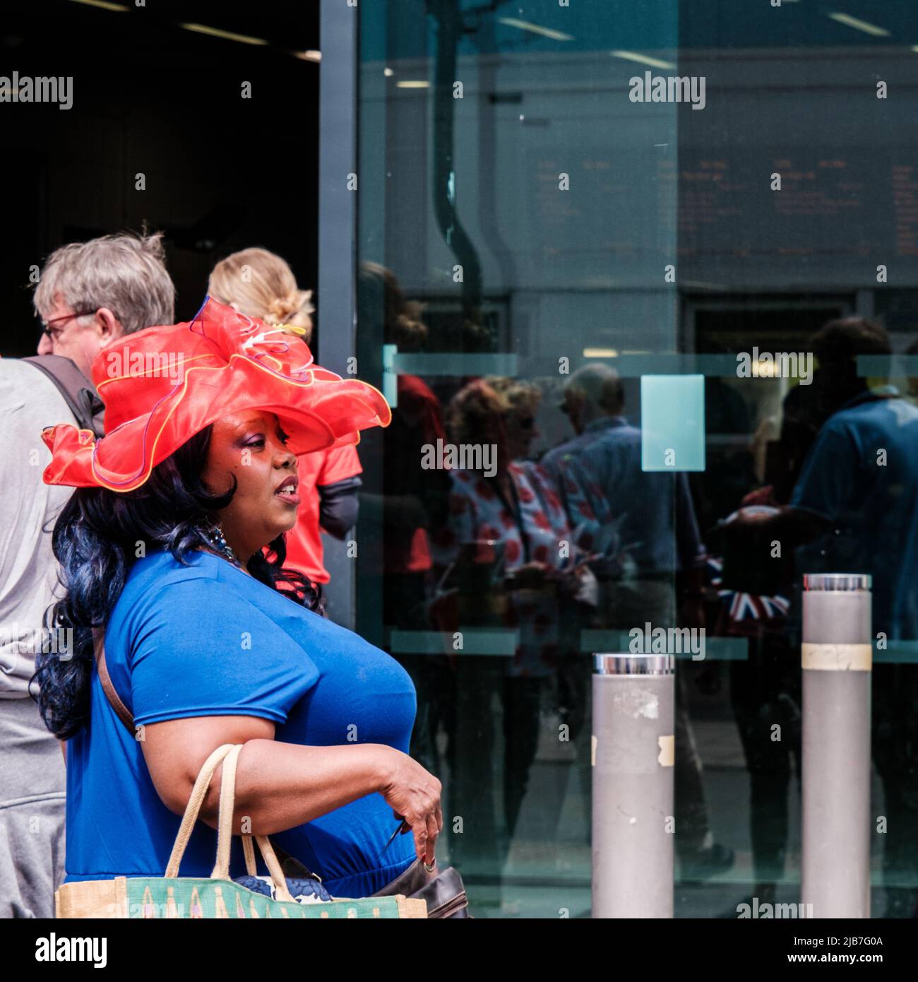 Epson Surrey, London, Großbritannien, Juni 03 2022, Schwarze Frau mit Red hat vor der Epsom Station Stockfoto