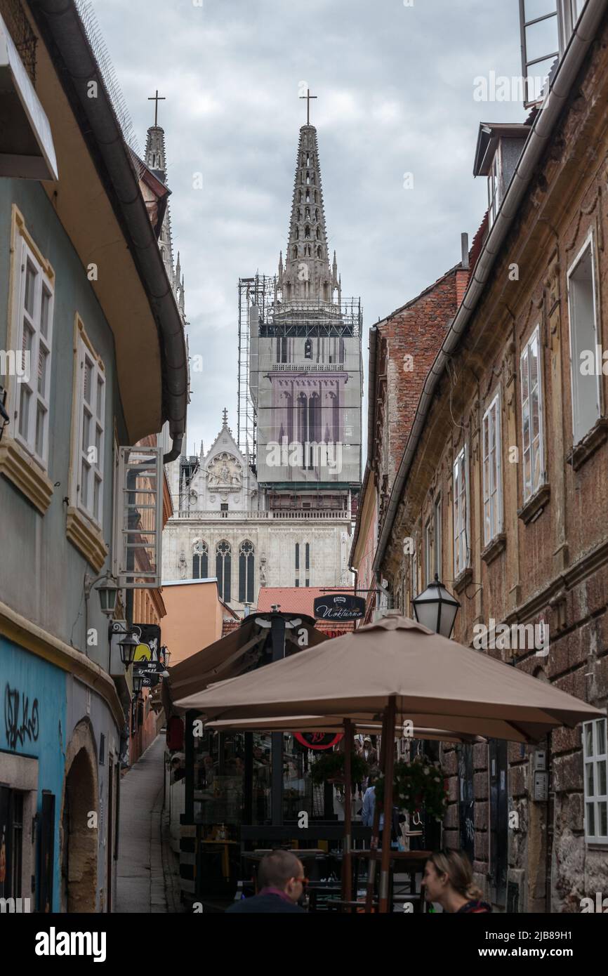 Bild der Skalisna ulica Straße in Zagreb, Kroatien, im Sommer mit Menschen sitzen in Bars und Cafés und der Turm der Kathedrale von Zagreb in Backgroun Stockfoto