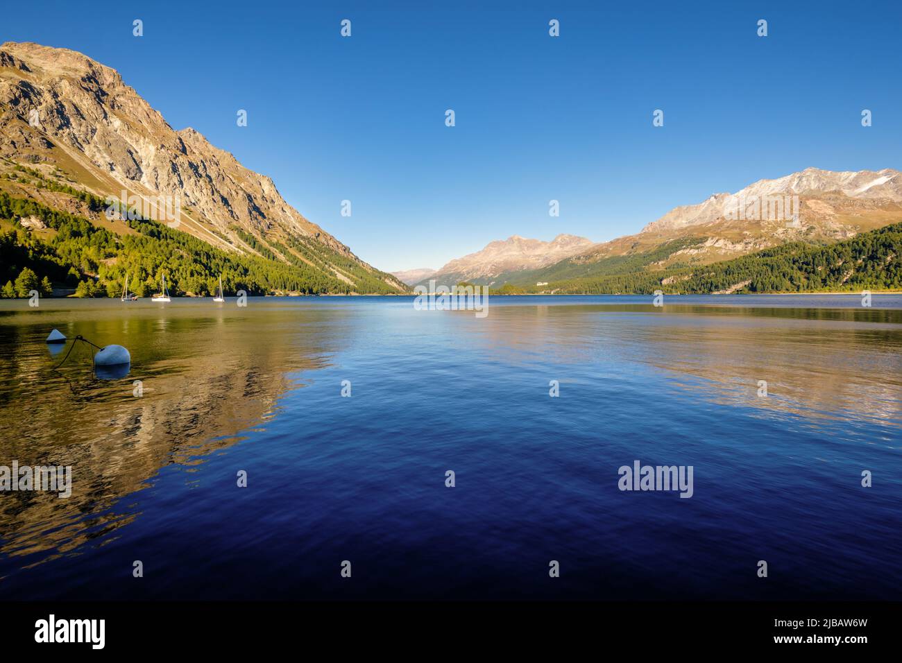 Im September geht die Sonne im herrlichen Plaun da Lej unter, einer berühmten Schweizer Bucht am Silbersee im oberen Engadintal (Grisons, Schweiz). Stockfoto