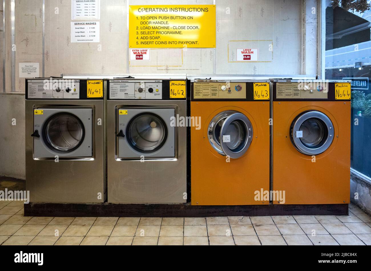 Münzwaschmaschinen im Waschsalon in Fitzrovia, Zentrum von London. Stockfoto