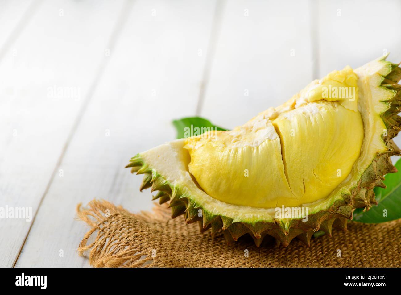 Durian und Durian Peels (Monthong) auf Sack und altem Holzhintergrund, König der Früchte aus Thailand in der Sommersaison Stockfoto