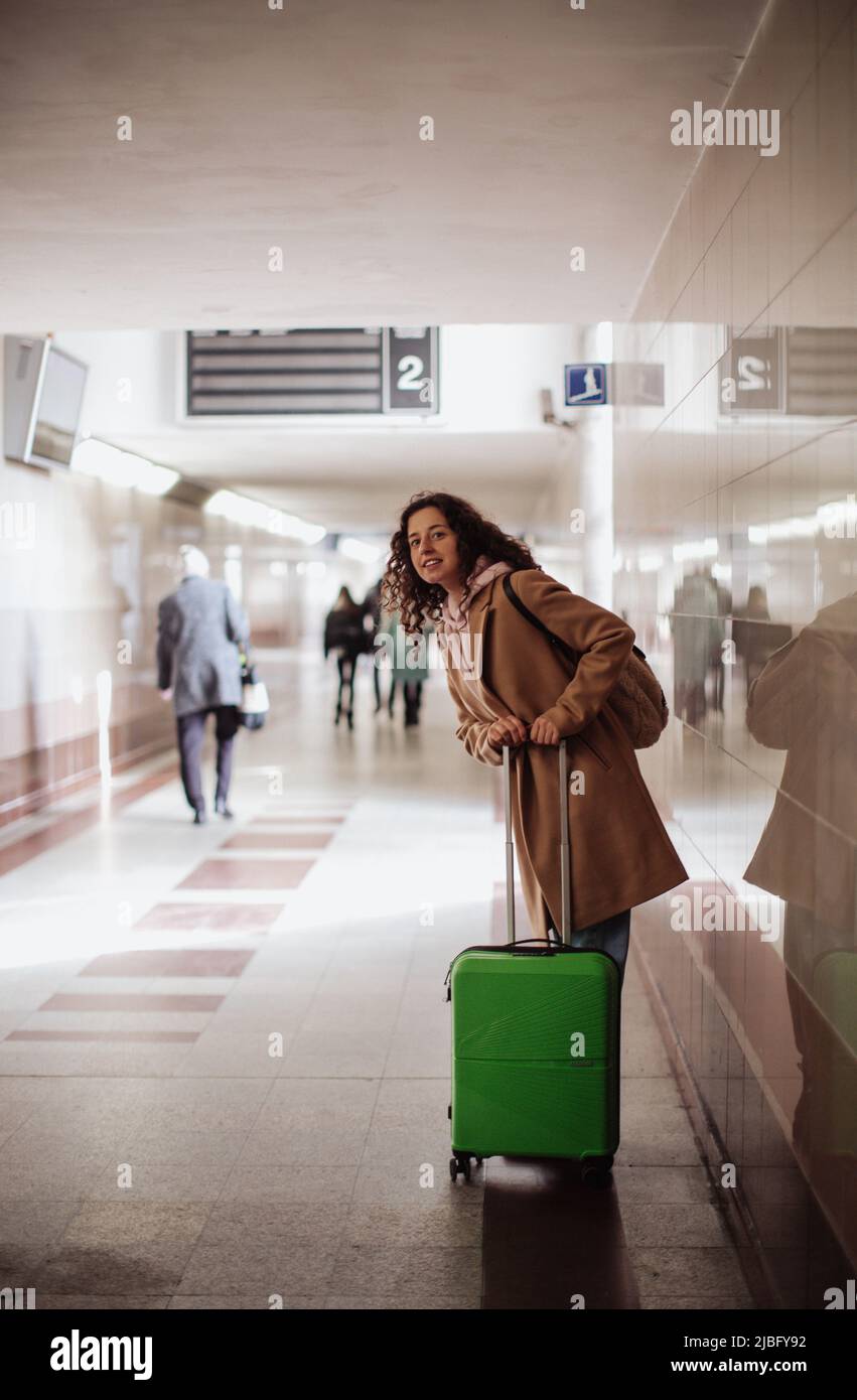 Frau, die als Tourist unterwegs war, mit Gepäck, das im Bahnhof stand und auf jemanden wartete. Stockfoto