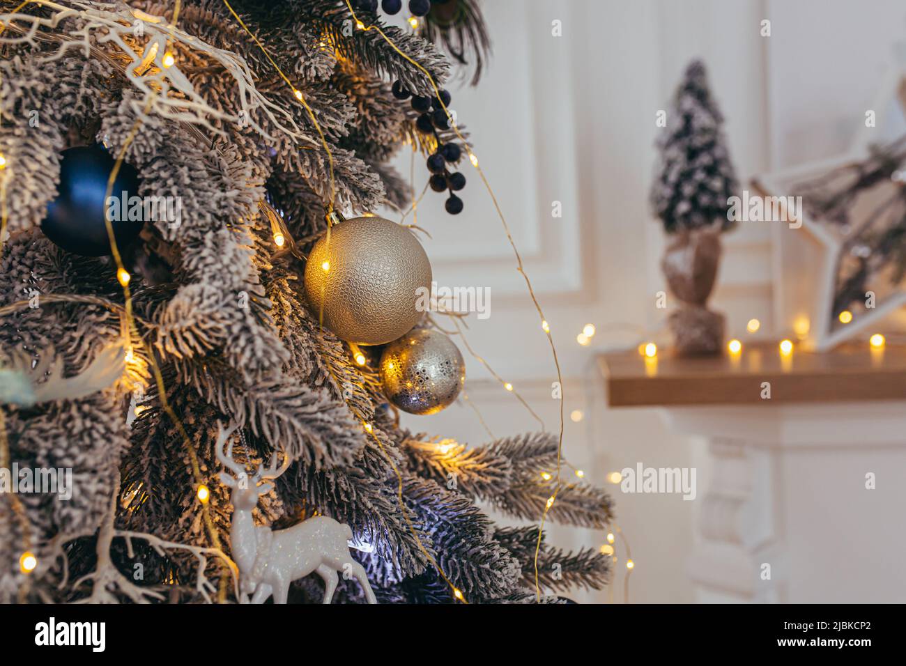 Nahaufnahme eines blauen Christbaumzweiges mit Gold- und Silberdekor Stockfoto