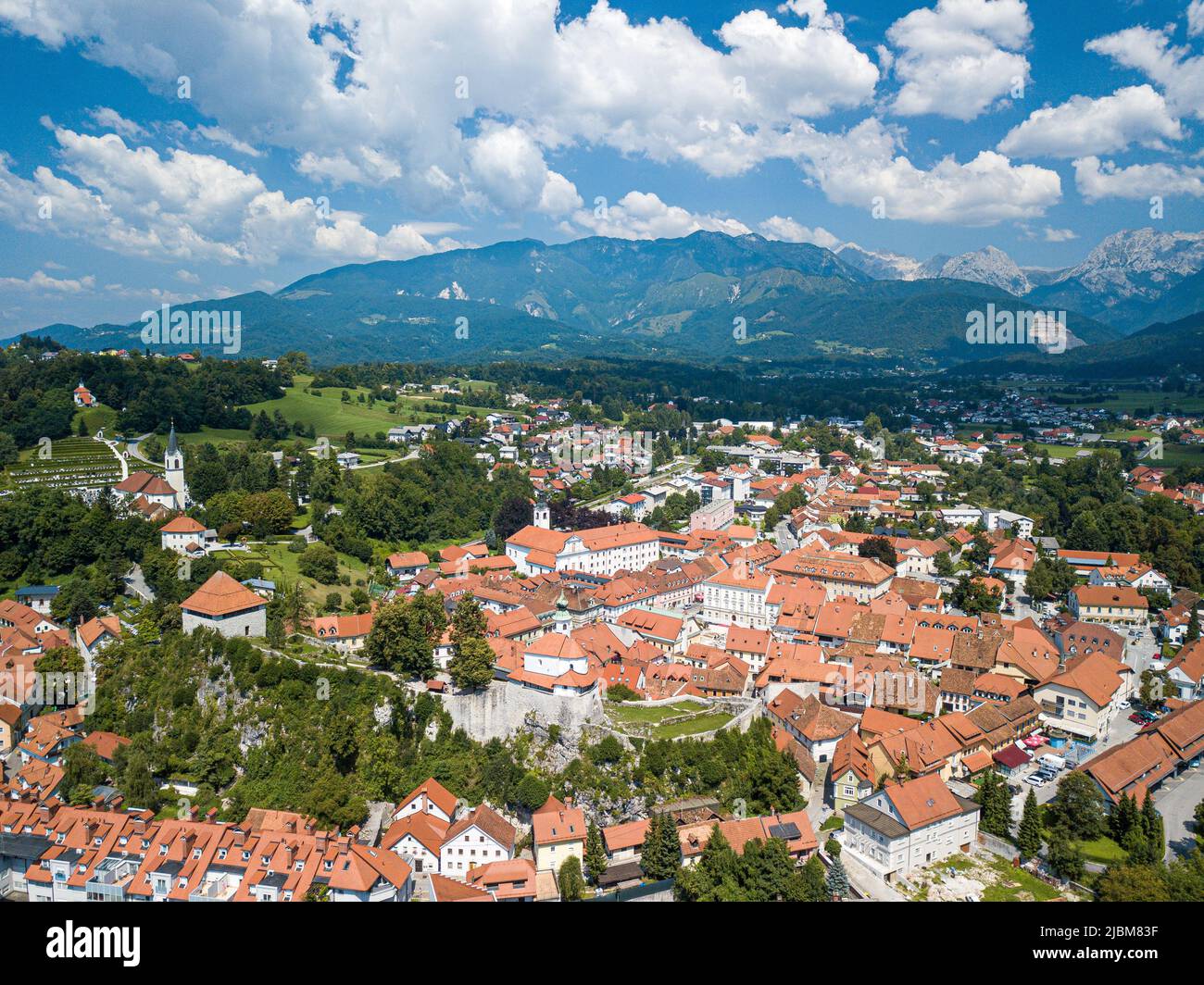 Luftbild mittelalterliche Stadt kamnik umgeben von üppigen Bäumen in den Kamnik-Savinja Alpen mit traditionellen slowenischen Häusern mit roten Dachziegeln. Stockfoto