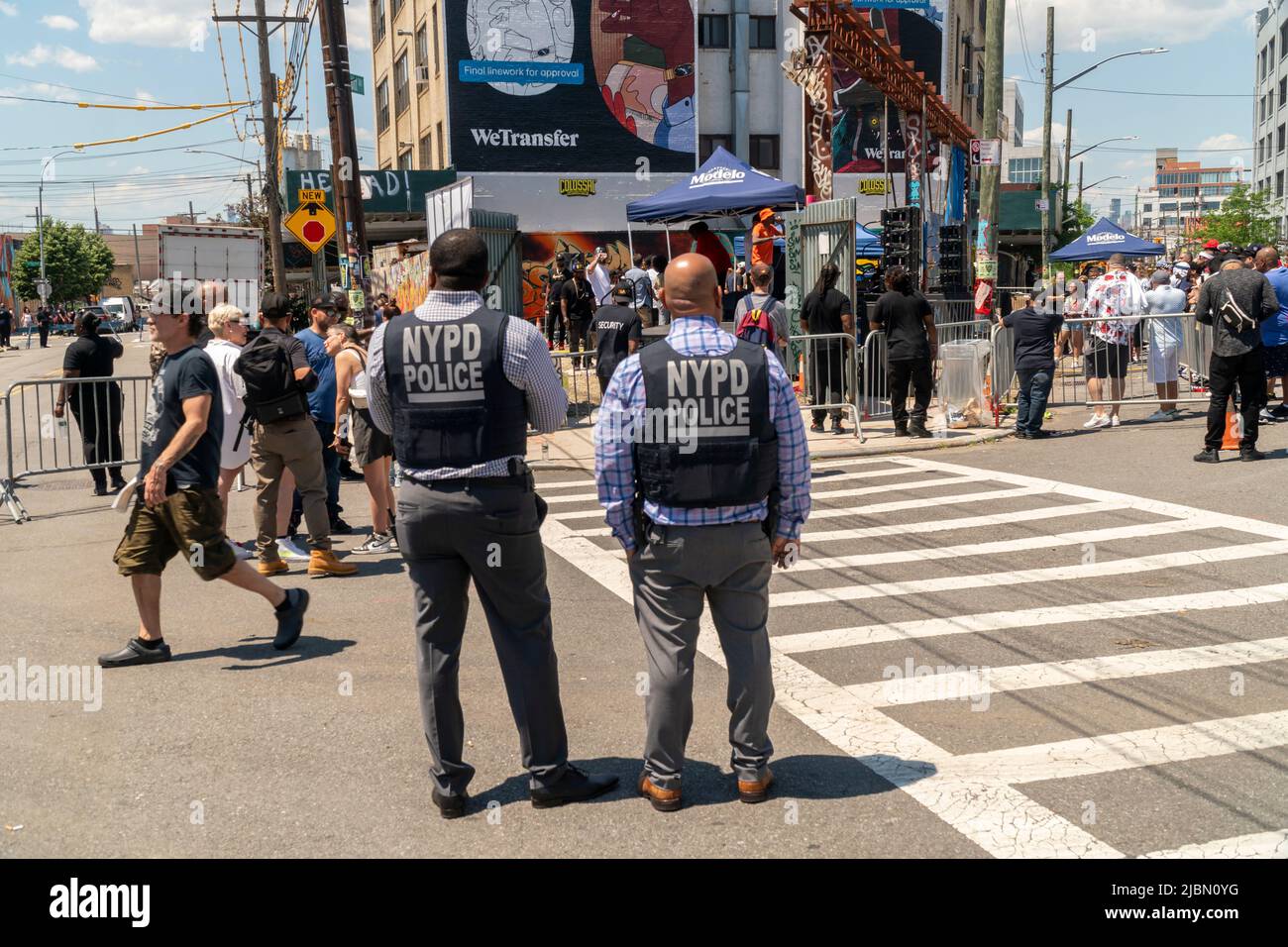 NYPD-Offiziere in Körperrüstung in Bushwick, Brooklyn, New York, während der jährlichen Bushwick Collective Block Party am Samstag, den 4. Juni 2022. Musik und Partys brachten einiges mit, aber die wahre Attraktion waren die neuen Wandgemälde von Graffiti-Künstlern, die die Wände der Gebäude schmücken, die das Kollektiv nutzt. (© Richard B. Levine) Stockfoto