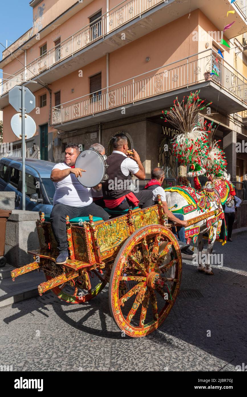 Traditionelle sizilianische Volksmusiker mit ihrem fröhlich geschmückten Pferd und Wagen beim jährlichen Erdbeerfest in Maletto, Sizilien, Italien Stockfoto