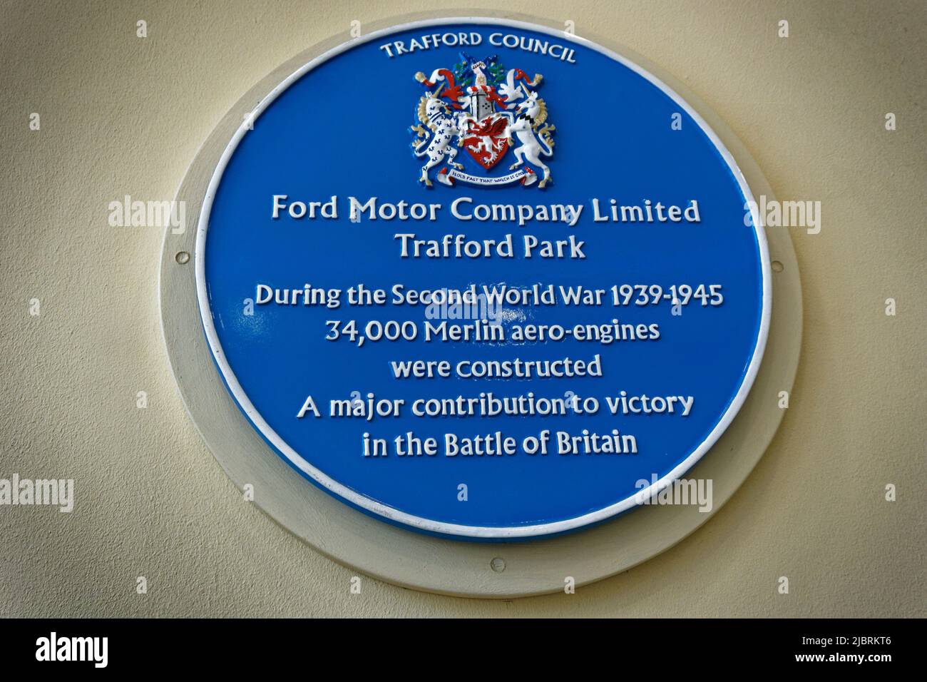 Blaue Plakette, die den Standort in Trafford markiert, an dem die Ford Motor Company im Weltkrieg 2 34000 Merlin Aero-Motoren in Lizenz von Rolls Royce fertigte. Stockfoto