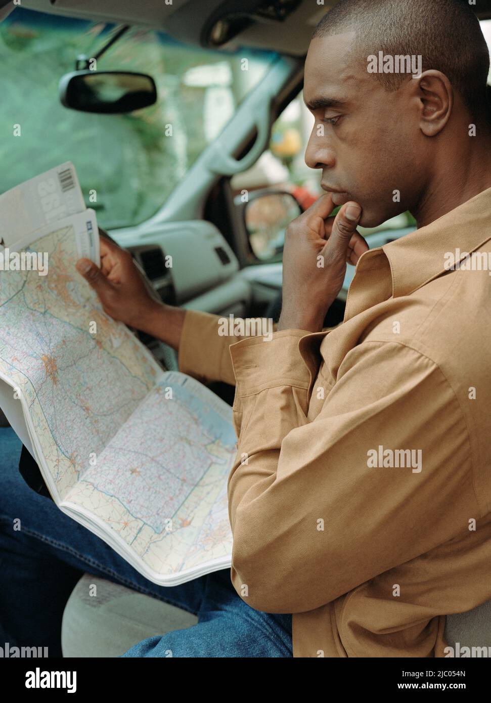 Mann liest Karte im Auto Stockfoto