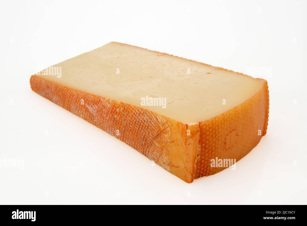 Fontina-Käsescheibe isoliert auf Weiß Stockfoto