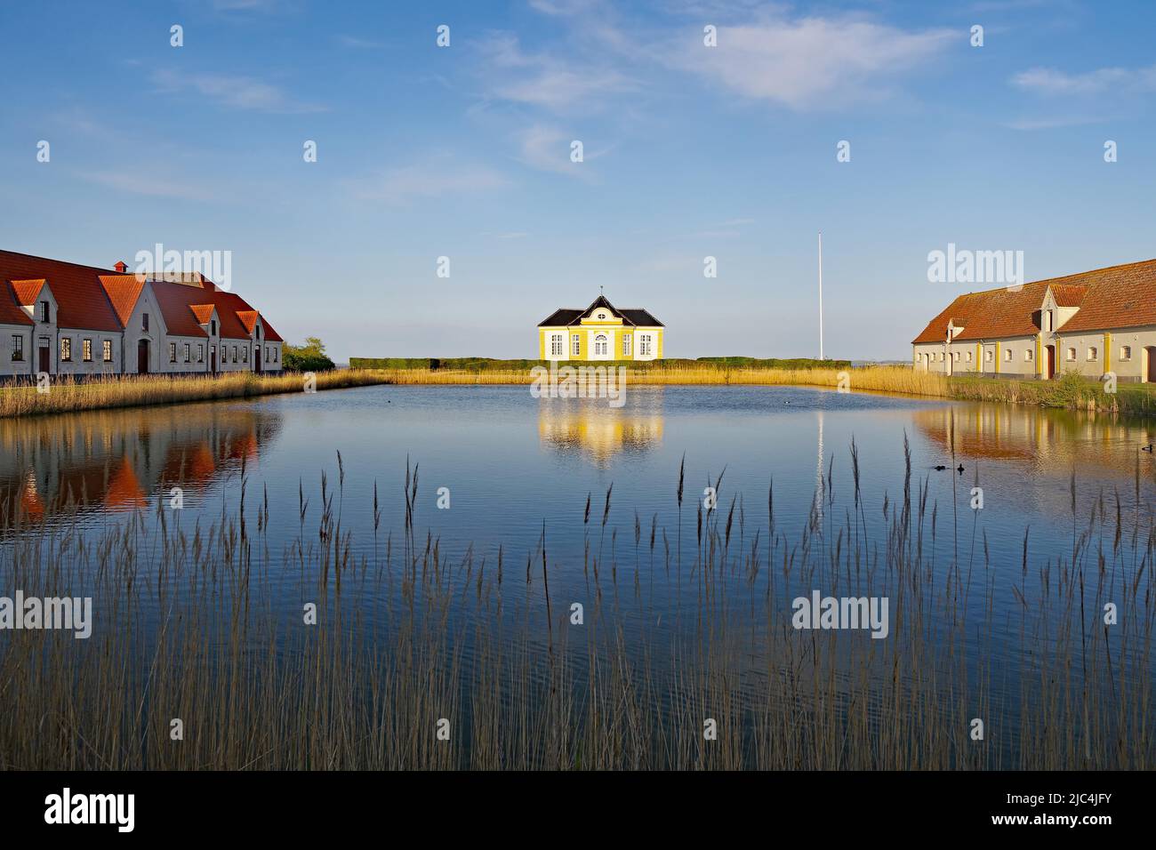 Teile einer Burg und Anwesen spiegeln sich in einem ruhigen Teich, Valdemars Slot, Tasinge, Dänemark Stockfoto