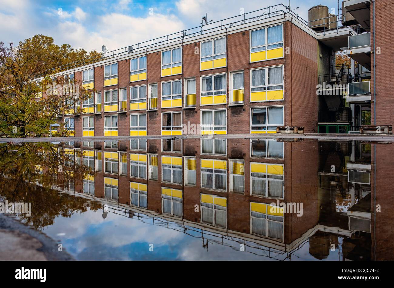 Als Wohnsiedlung in London spiegeln sich Wohnungen auf einer Pfütze auf der Oberseite oder Garagen wider. Stockfoto