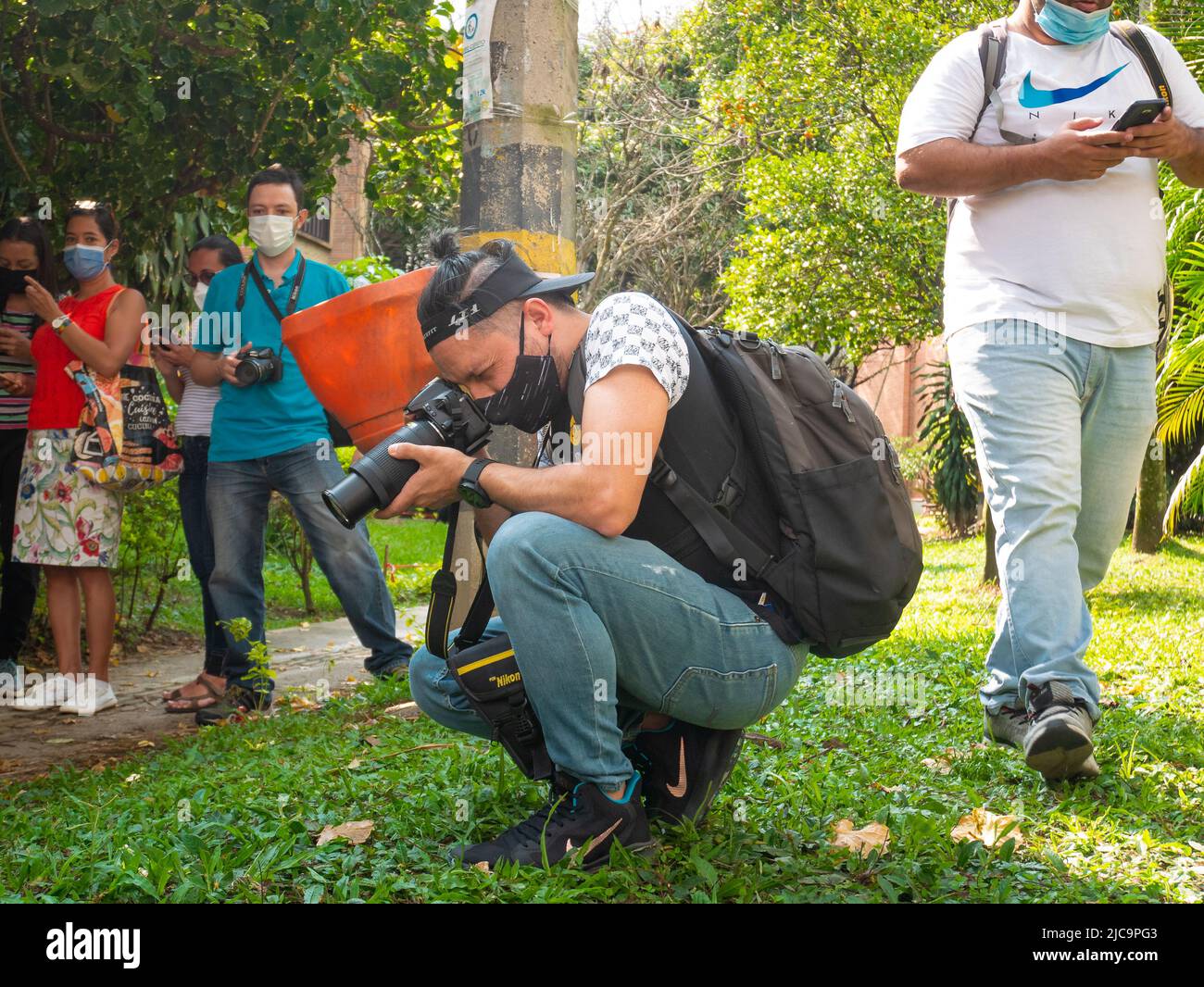 Medellin, Antioquia, Kolumbien - Februar 19 2022: Ein junger kolumbianischer Mann macht Bilder von Insekten und Pflanzen in einem wunderschönen Garten Stockfoto