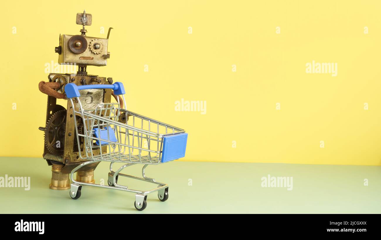 Ein alter Roboter mit einem Warenkorb. Symbol für den Online-Handel. Leerer Raum. Stockfoto