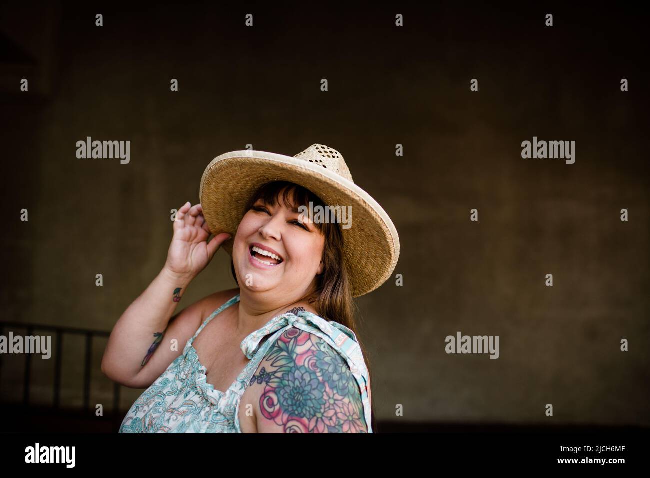 Plus Size-Modell trägt Hut und ärmelloses Kleid in San Diego Stockfoto