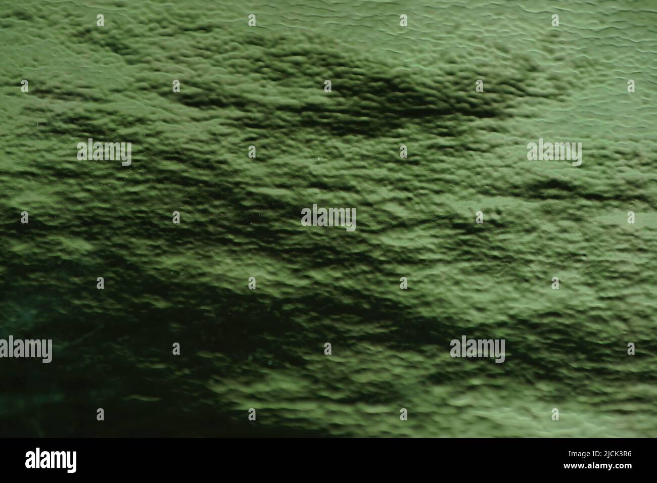 Sattgrüner Hintergrund mit Lichtreflexion. Anahata Chakra Farbton. Stockfoto