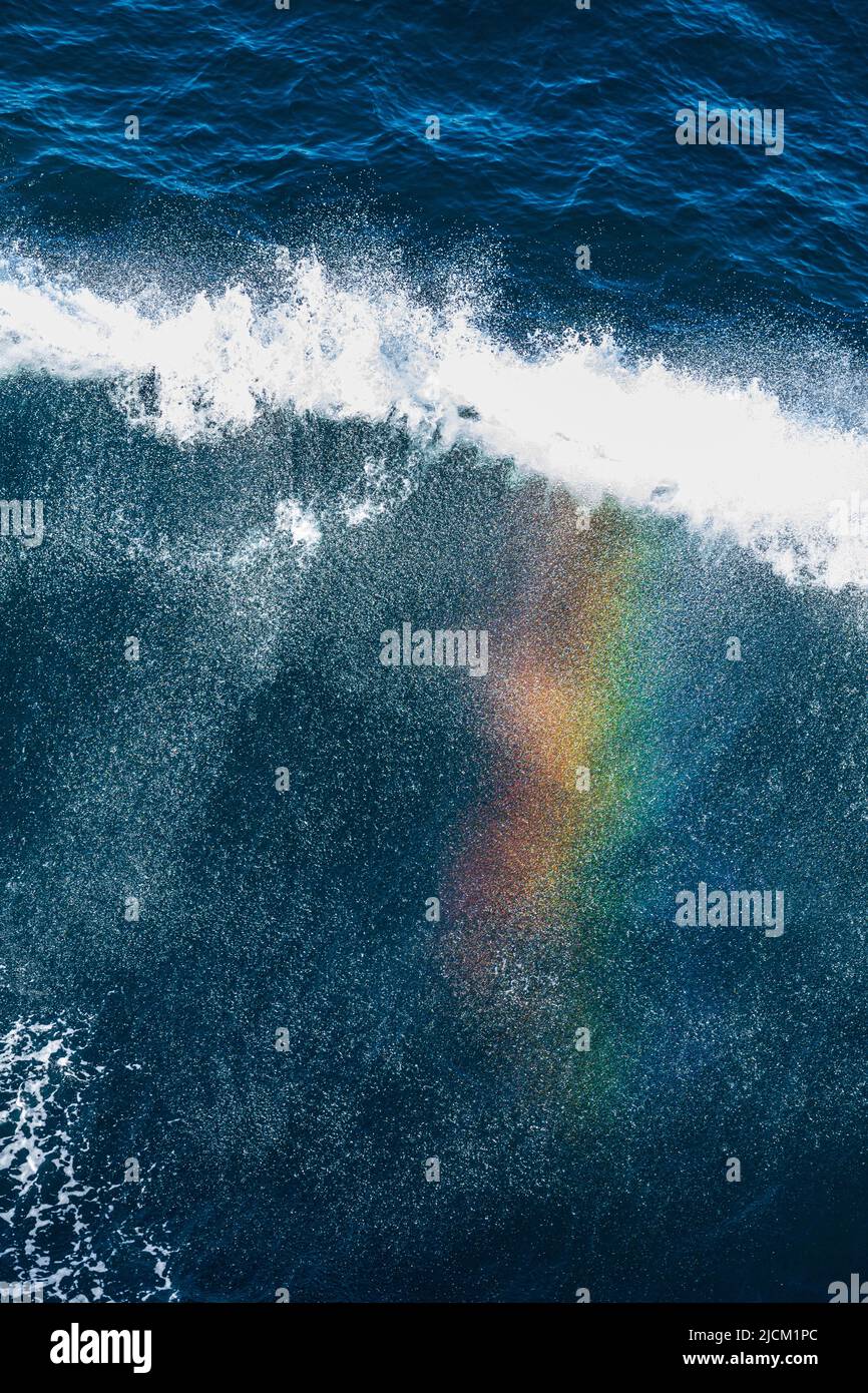 Ein Regenbogen, der im Spray der Bugwelle eines Kreuzschiffs im Skagerrak vor Dänemark zu sehen ist Stockfoto