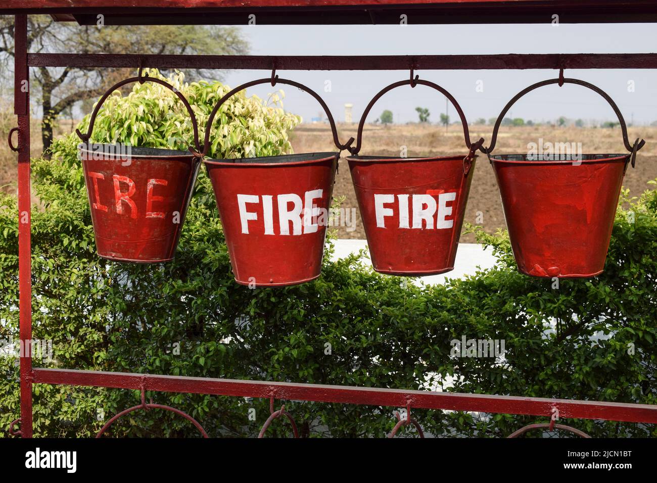 Rote Feuereimer mit Sand zum Schutz im Brandfall Brandschutz, sandgefüllter Eimer zum Schutz vor Feuer an der Benzinpumpe Stockfoto