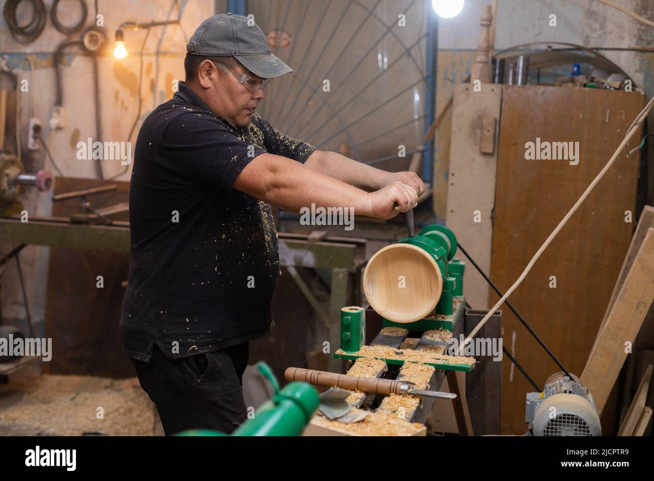 Zimmermann bereitet Maschine für das Drehen von Holz auf einer Drehbank vor  Stockfotografie - Alamy
