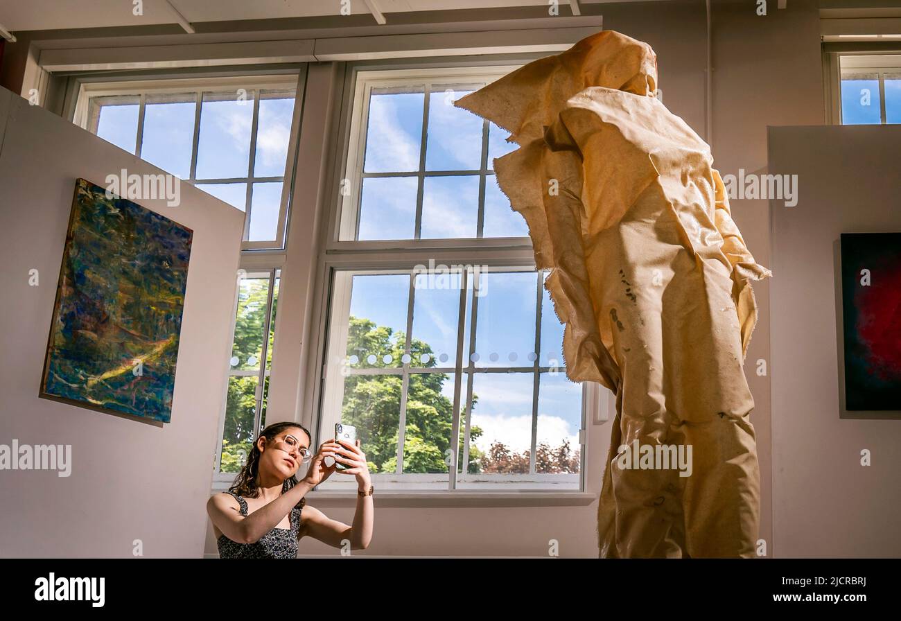 Die Kuratorin Florence Kitching fotografiert ein Kunstwerk mit dem Titel „The Ghost of You“ der Künstlerin Charlotte Long, das Teil der Kunstausstellung an der University of Leeds ist. Bilddatum: Mittwoch, 15. Juni 2022. Die diesjährige Studienschau feiert die Arbeit von 62 Absolventen, die sich durch alle Medien zeitgenössischer Kunst erstrecken Stockfoto