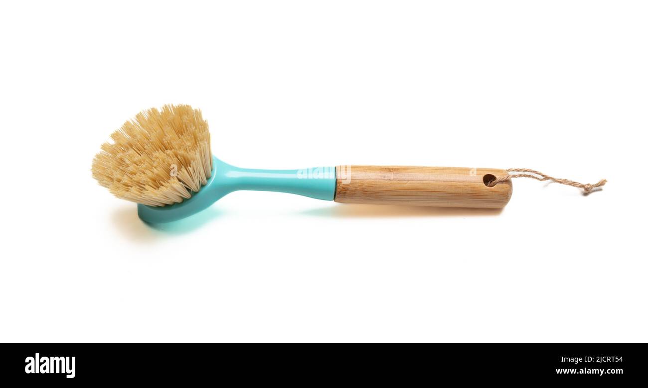 Isolierter Ausschnitt der Spülbürste auf weißem Hintergrund. Blaue Pastellbürste mit Holzgriff. Küchenausstattung. Stockfoto