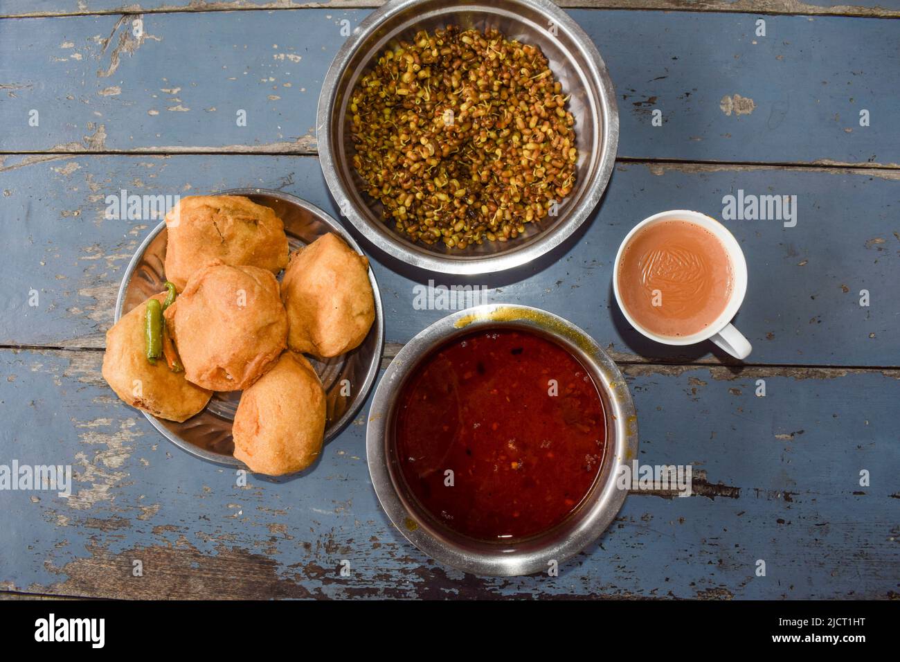 Aloo Batata Vada ist beliebtes Mumbai Essen, Maharastrian Street Essen gegessen mit rassa und gekeimt serviert mit ganz grün kühl und ussal Stockfoto