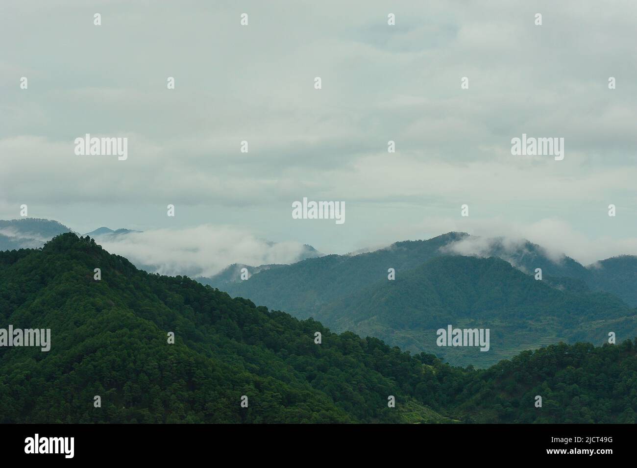 Mountain Province, Philippinen: Majestätische Berglandschaft in Sagada, eingehüllt in Nebel an einem düsteren Tag. Horizontaler Kopierbereich mit Naturmotiven. Stockfoto
