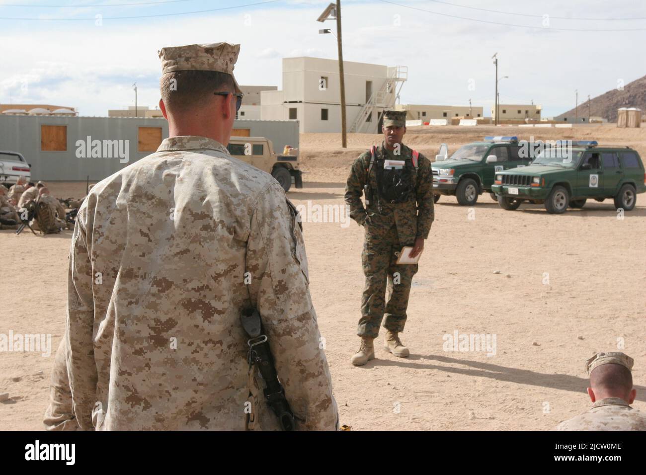 Eine US-Marine mit 1. Bataillons, 8. Marine Regiment (1/8), 2D Marine Division, hört einem Enhanced Mojave Viper Evaluator über die Ausbildung in Stockfoto