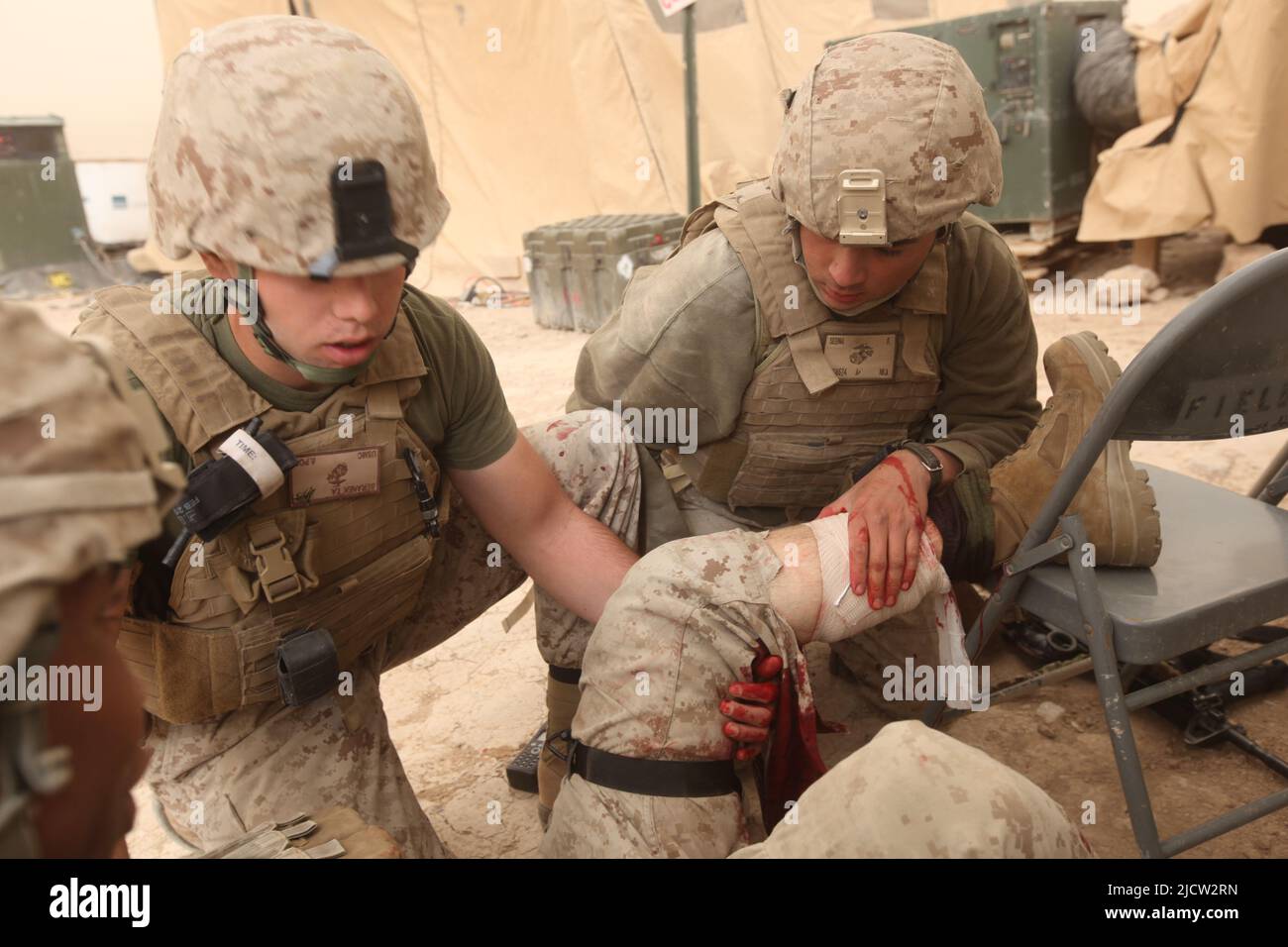 US-Marineinfanteristen und Marinesoldaten leisten erste Hilfe für eine Waffe, die Marine während eines Feuergefechtes in Kajaki, Afghanistan, verletzt hat. Stockfoto