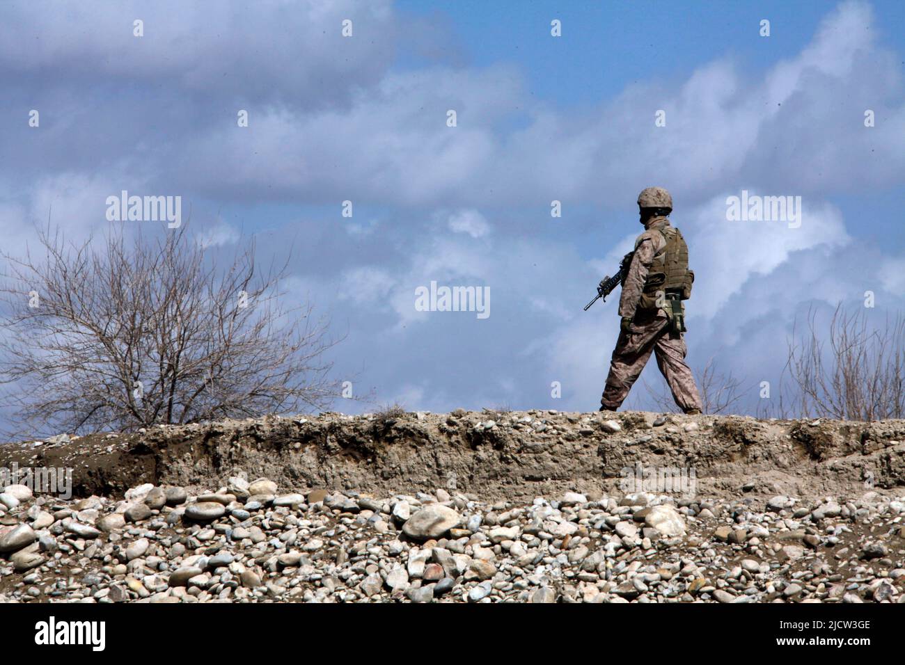 Eine US-Marine mit 1. Bataillons, 8. Marine Regiment (1/8), Regimental Combat Team 6, patrouilliert durch ein afghanisches Feld in Kajaki, Provinz Helmond, Stockfoto