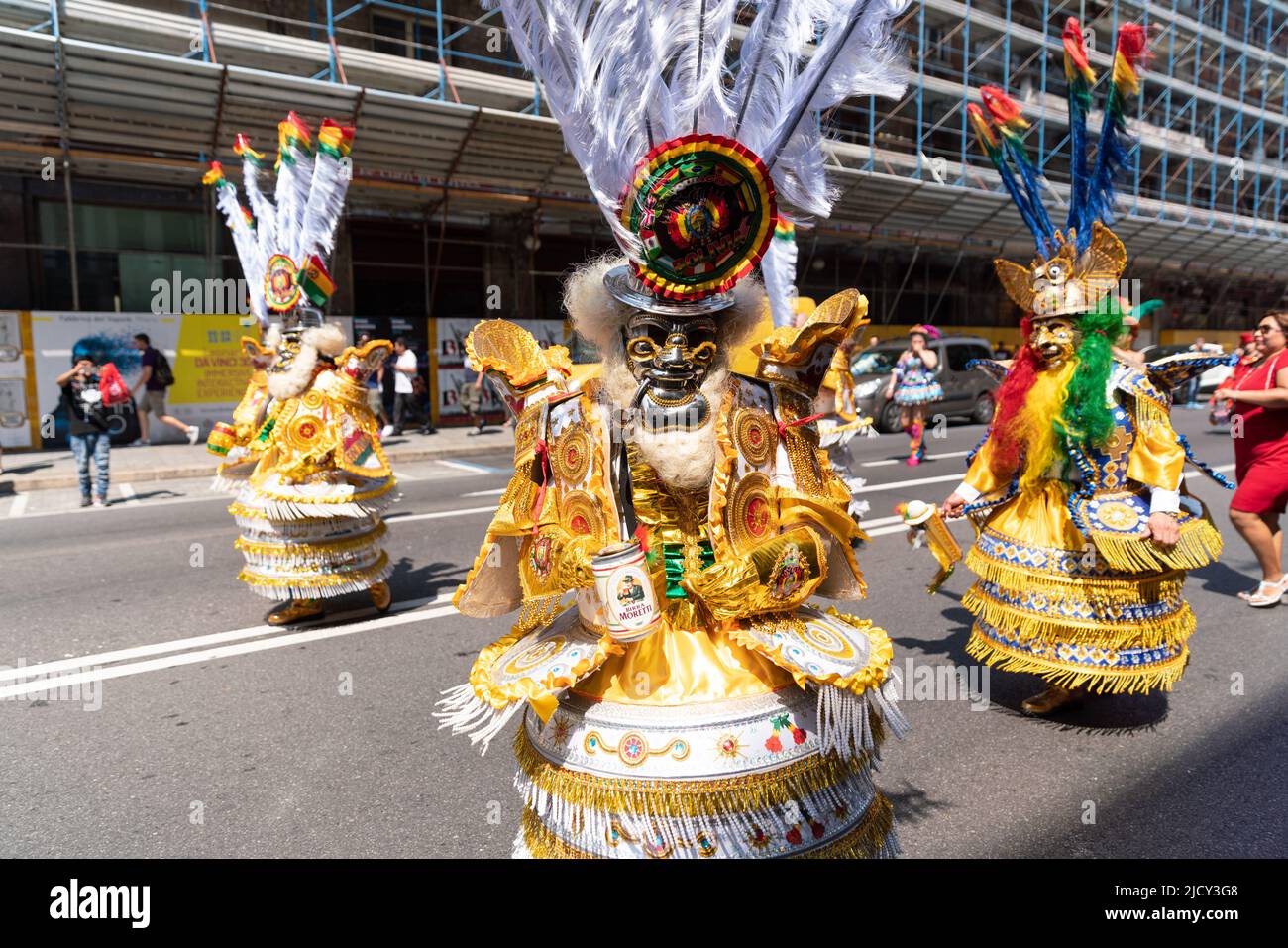 Bunte Maskentänzer in gelbem Kleid feiern während des bolivianischen Festivals der Jungfrau von Urkupiña in den Straßen von Mailand, Italien, Europa Stockfoto