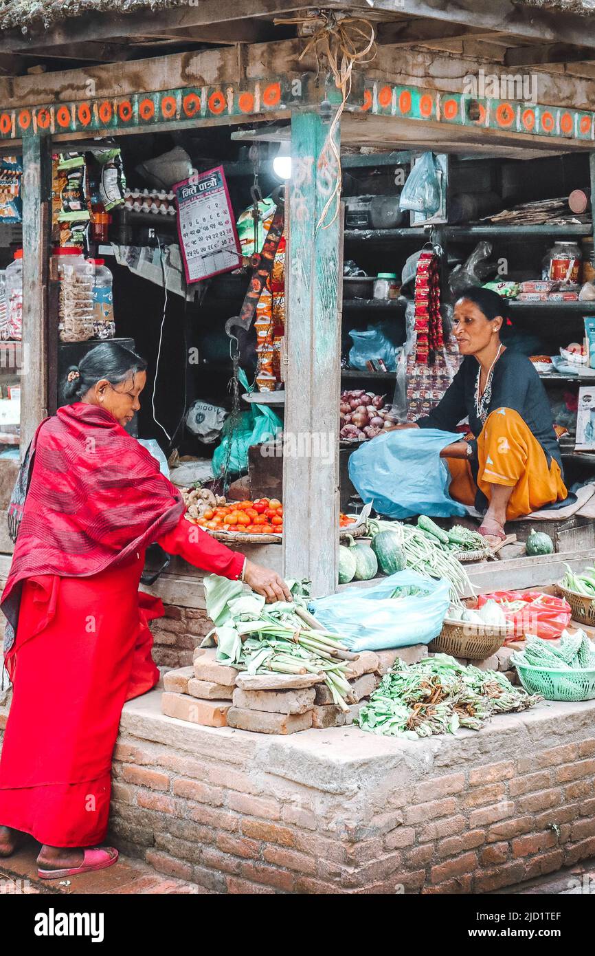 Frauen, die in ihrem kleinen Laden in bhaktapur, einer Stadt in Newari im Kathmandu-Tal, Waren wie Gemüse verkaufen Stockfoto