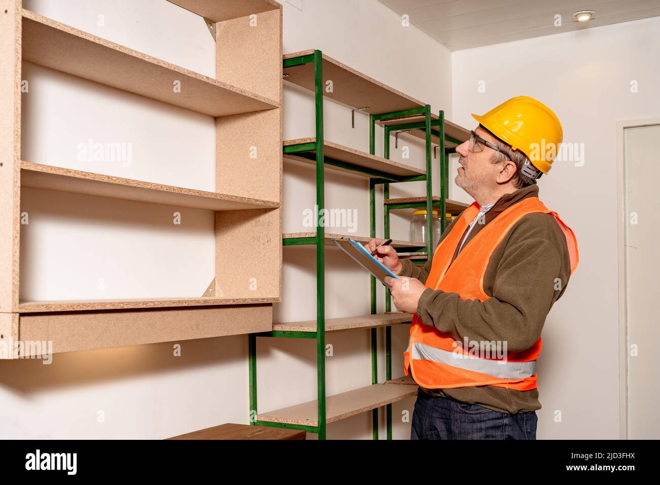 Kaukasischer Inspektor, der den Status und den Fortschritt der Arbeit im Arbeitsamt überprüft. Konzept der Arbeitsorganisation, Inspektion, Stockfoto