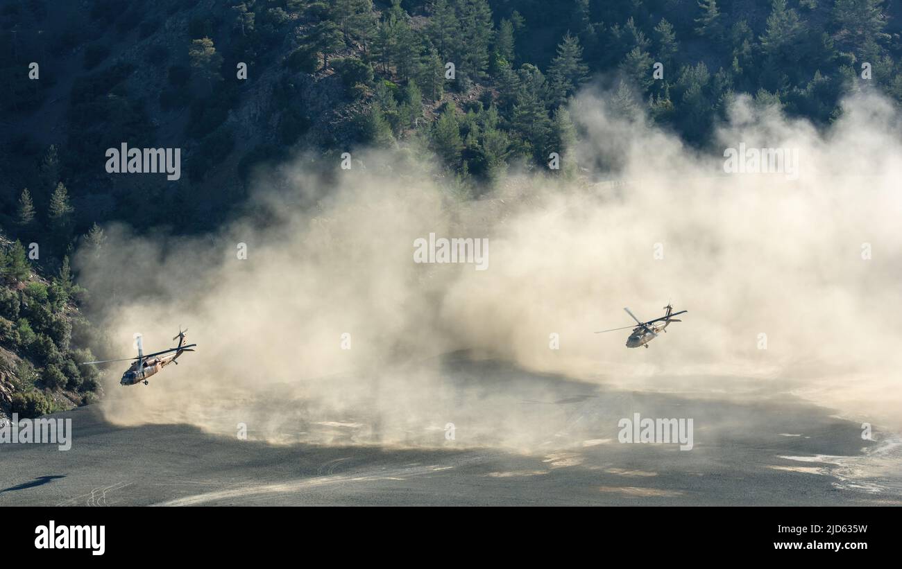 AMIANTOS, ZYPERN - 2. JUNI 2022: Zwei israelische Sikorsky UH-60 Black Hawk Hubschrauber fliegen tief zu Boden in Staubwolken während des gemeinsamen Zypern-Isra Stockfoto
