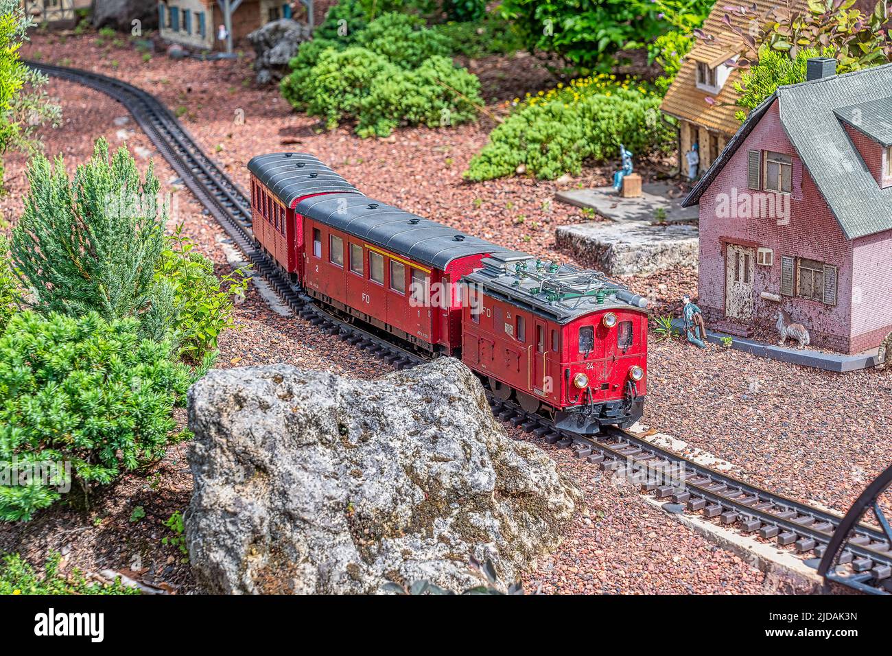 Kleines Modell eines Zuges, der auf modellierten Gleisen läuft Stockfoto