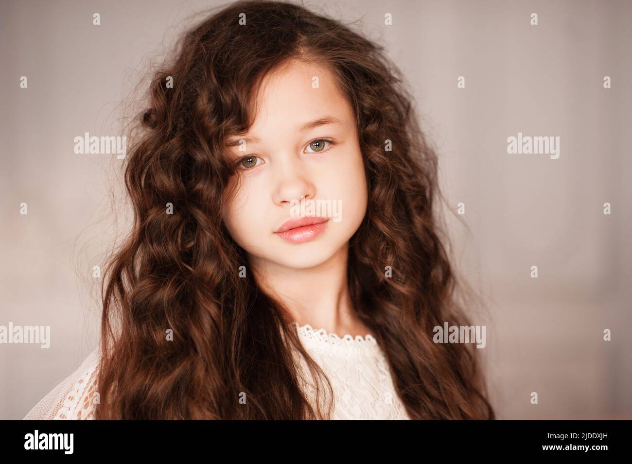 Cute schöne Kind Mädchen 10-12 Jahre alt mit langen dunklen blonden Haaren im Zimmer Nahaufnahme. Porträt eines jungen Teenagers. Kindheit. Stockfoto