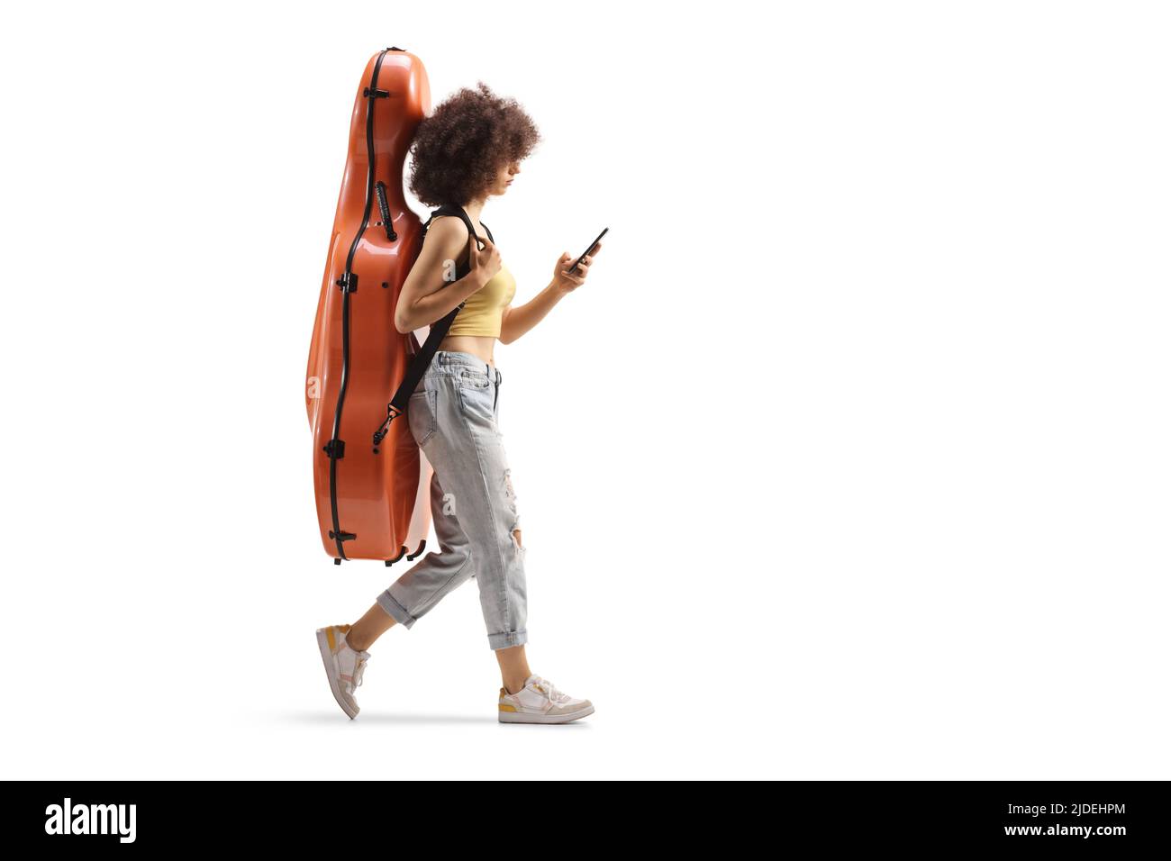 In voller Länge Profilaufnahme einer jungen Frau, die mit Cello in einem Gehäuse und mit einem Smartphone auf weißem Hintergrund isoliert geht Stockfoto