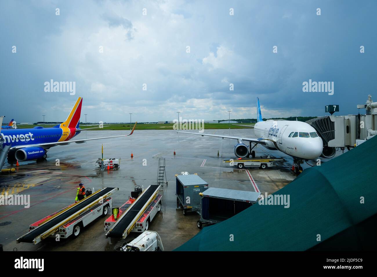 Stock-Bilder von South West und JetBlue Airlines. Aktuelle Flugverspätungen in den USA. Bodenpersonal, das Flüge und Gepäckförderer verwaltet. Stockfoto